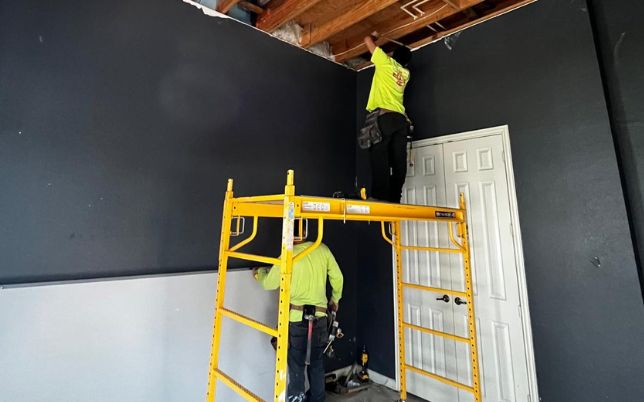 Ceiling installation in Houston TX by remodeling contractors working on interior structureprofessional remodeling contractors working on interior ceiling