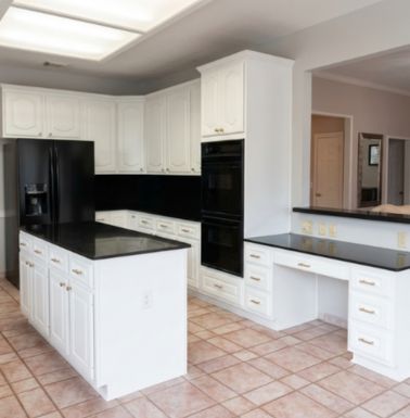 Kitchen remodeling in Houston TX with white cabinets, island, and modern interior finishes